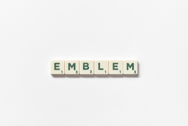 Emblem formed of scrabble tiles on white background