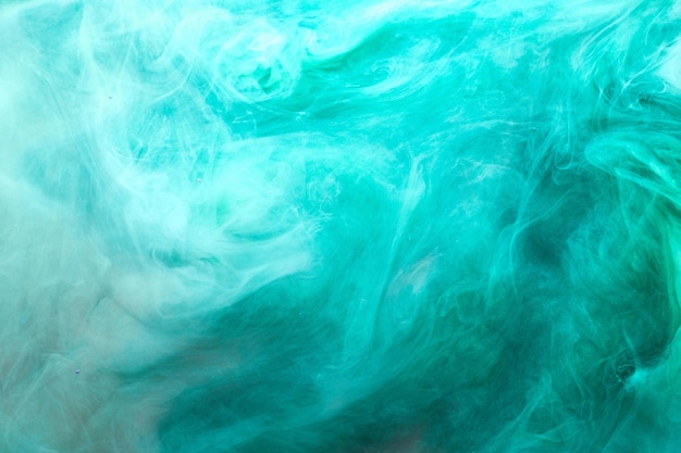 Emerald abstract background luxury smoke acrylic paint underwater explosion cosmic swirling aquamarine ink