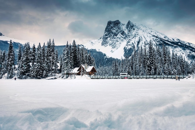 Emerald Lake with wooden lodge and rocky mountains with snow covered on winter at Yoho national park