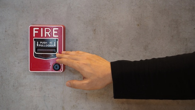 Emergency of Fire alarm or alert or bell warning equipment and hand.In the building for safety.