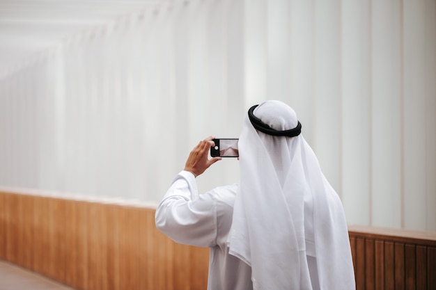 Emirati guy taking selfie in the urban city lifestyle downtown the heart of Dubai