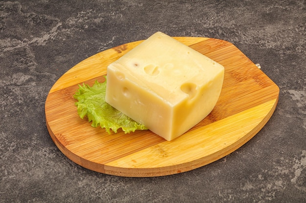 Emmental cheese over wooden board