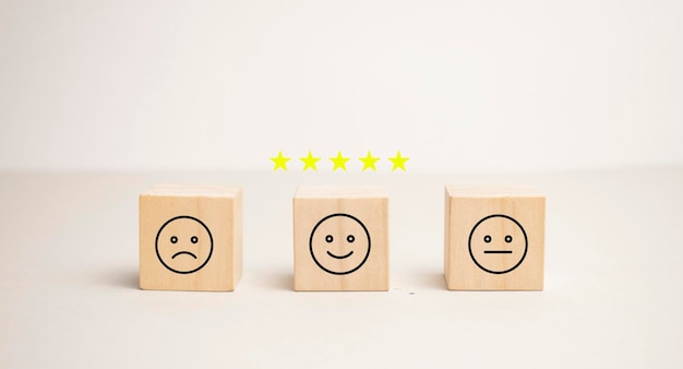 Emotion face symbol on wooden blocks mood Service rating ranking customer review satisfaction evaluation and feedback concept