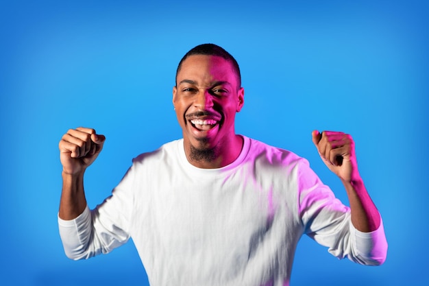 Emotional african american man gesturing on colorful background