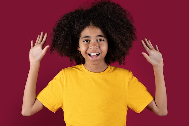 Emotional black child raising hands up and screaming