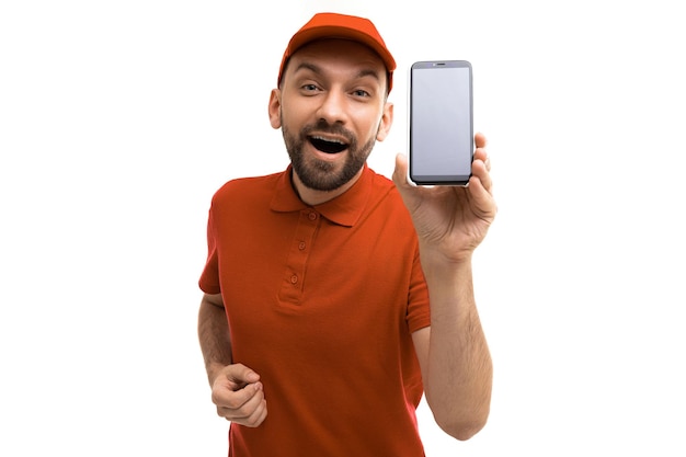 Emotional charismatic couriers in red uniforms demonstrate an application on a smartphone screen