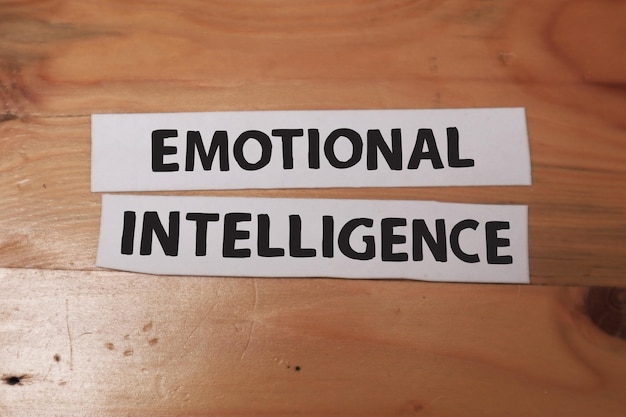 Photo emotional intelligence text words typography written on paper against wooden background