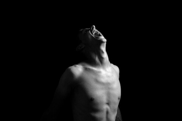 Emotional photo, man shouting on black background