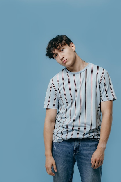 Emotional portrait of a young man on a blue background