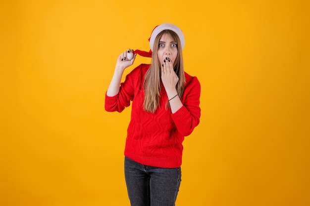 Emotional woman wearing santa hat and red sweater