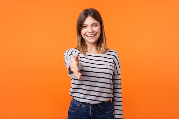 Emotional young brunette woman on orange background