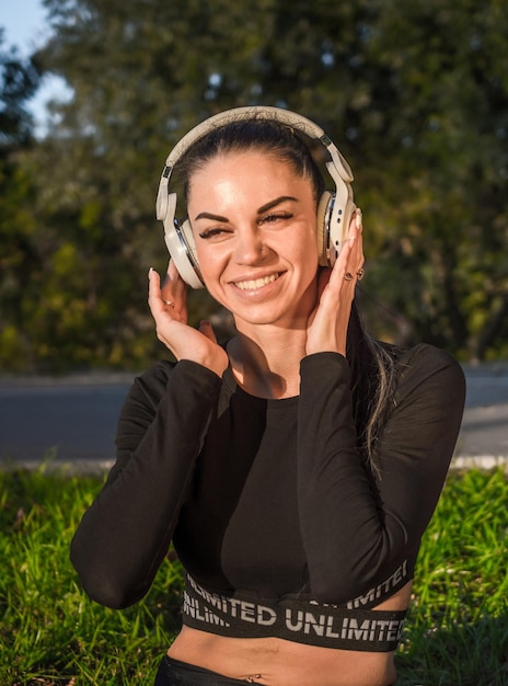 Emotional young woman lying and relaxing with headphonesNice girl listening to music