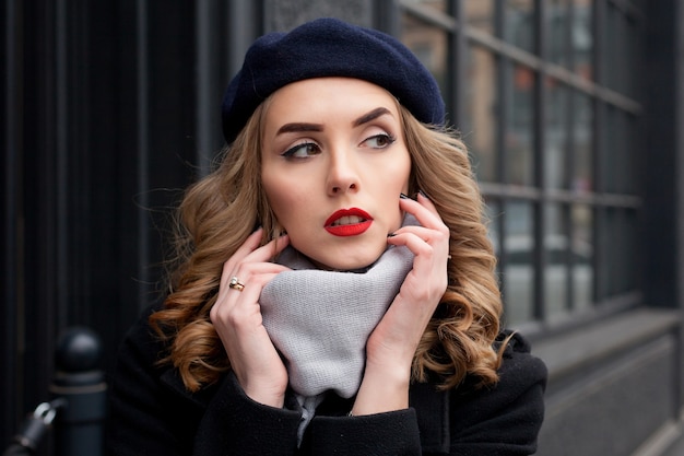 Emotions, people, beauty and lifestyle concept - Girl Frenchwoman. Street photo of young woman wearing stylish classic clothes. Female fashion concept. French style.