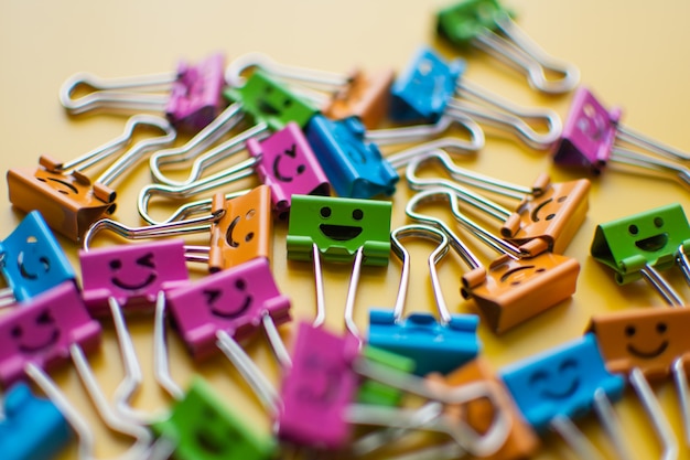 Emotipaper clip yellow background. subject is blurry.