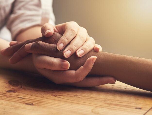 Empathy trust and support with people holding hands as friends in solidarity in cancer pain grief or loss Mental health depression and love between friends during prayer together or faith in god