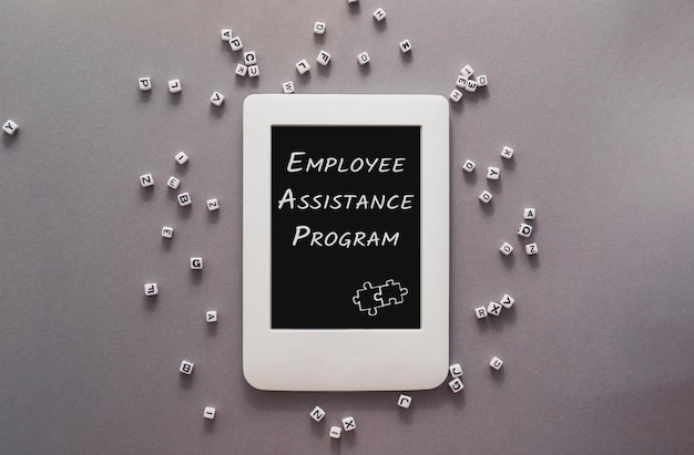 Employee assistance program on tablet screen on grey