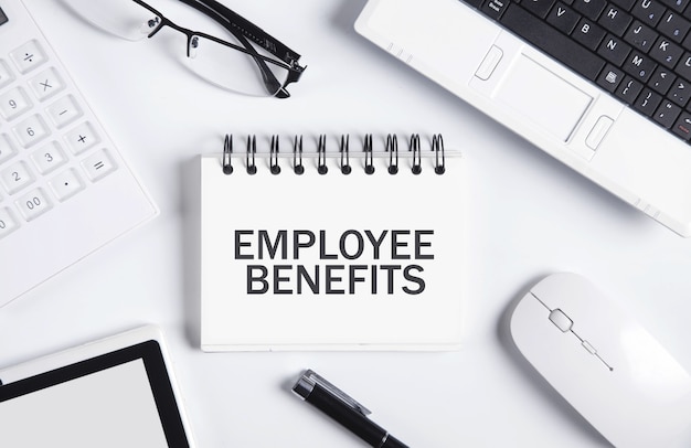 Employee benefits on a notepad with a business objects.