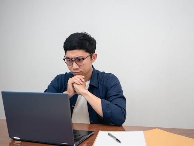 Employee male sit working feels serious with work at workplace table