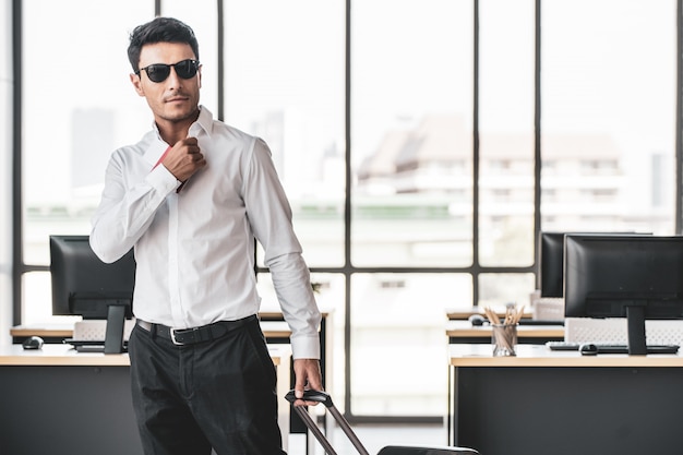 Employee in office ready to travel on summer vacation holidays.