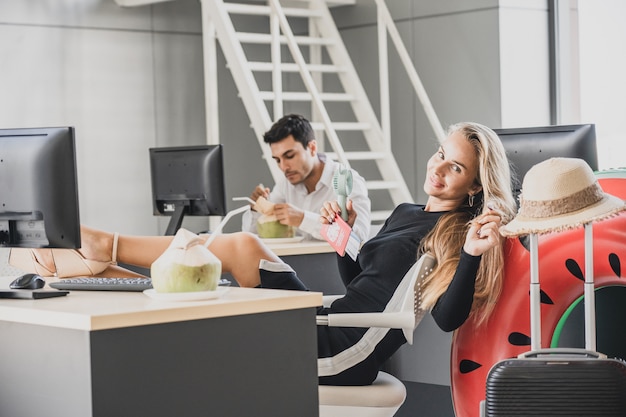 Employee in office ready to travel on summer vacation holidays.