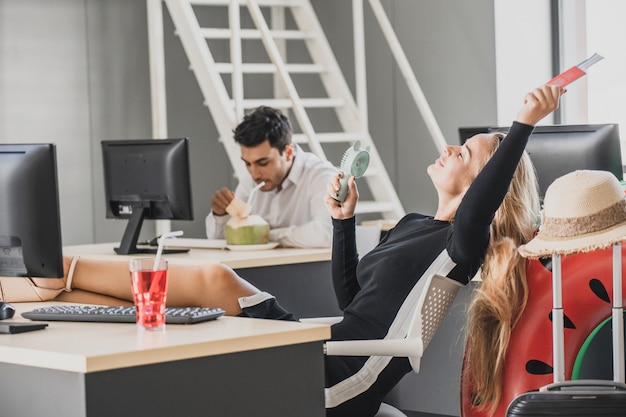 Employee in office ready to travel on summer vacation holidays.