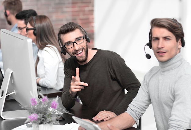 Photo employees of the business center with a headset in the workplace