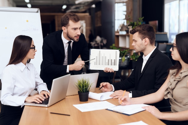 Employees of company hold a meeting at the table.