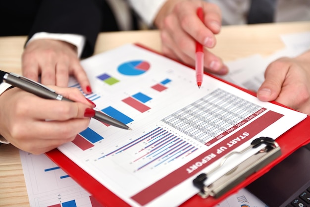 Employees discussing business chart in office