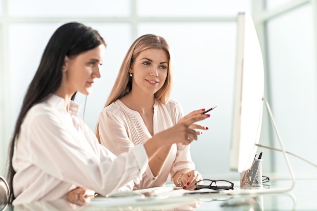 Employees discussing something sitting at the office table