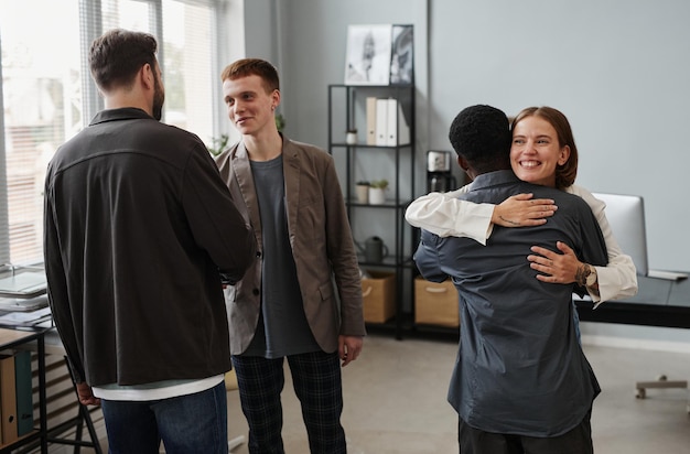 Employees greeting each other at office