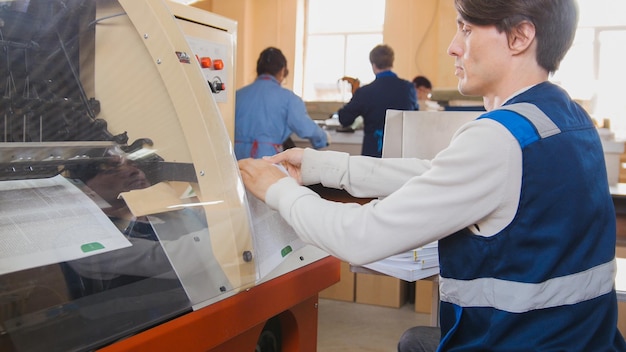 Employees of printing production at work, in a printing factory