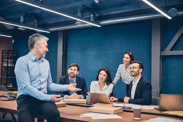 Employees sitting and holding a meeting at a large table