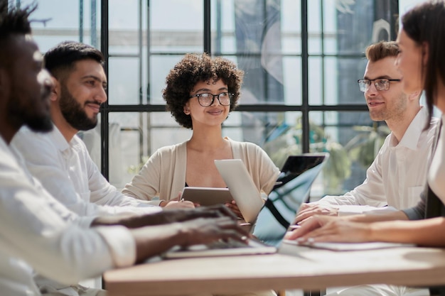 Employees working at computer together discussing content