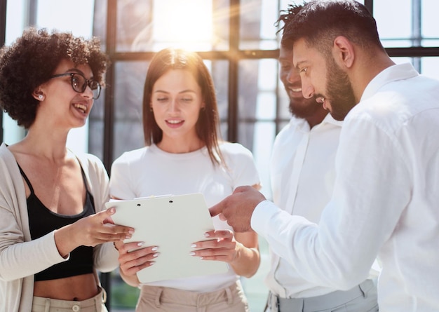 Employees working at computer together discussing content