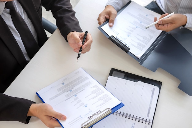 Employer arriving for a job interview, businessman listen to candidate answers explaining about his profile and colloquy dream job, manager sitting in job Interview talking in office