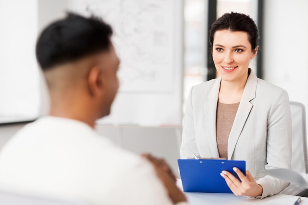 Photo employer having interview with employee at office