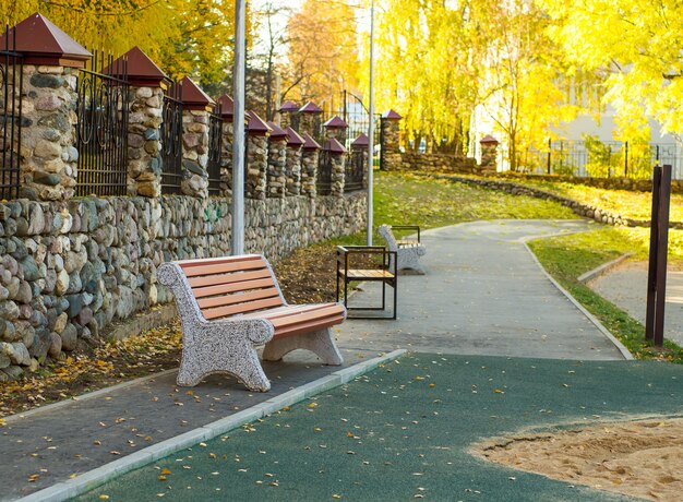 Empty bench on a summer day in an autumn park