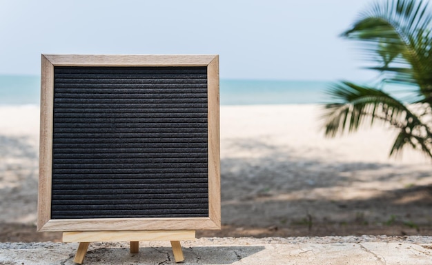 Empty black blank board on sea beach vacation well editing text on free space for promotion projects