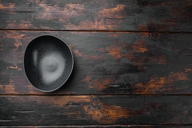 Empty black bowl with copy space for text or food with copy space for text or food top view flat lay on old dark wooden table background