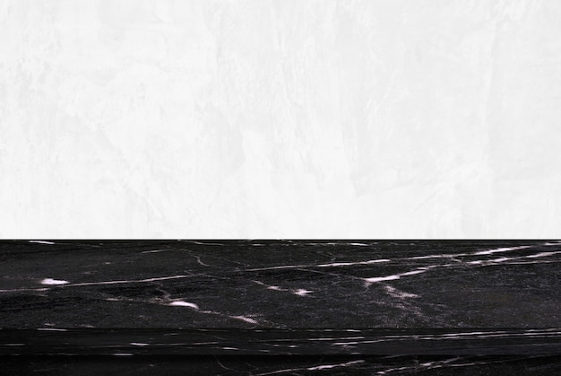 Photo empty black marble table over white cement wall background