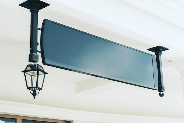 Empty black rectangular signage with lantern on building with classical architecture and daylight Mock up