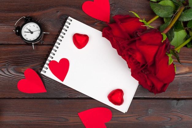 Empty blank notebook, gift box, flowers on a white background