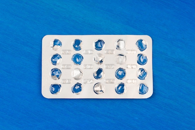 Empty blister pack of tablets on a blue background