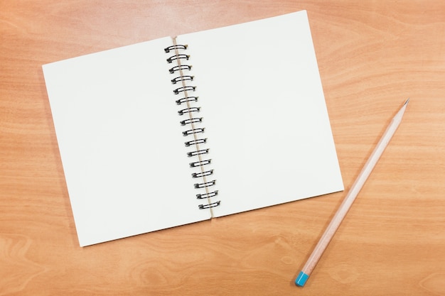 Empty books and pencils on wooden boards