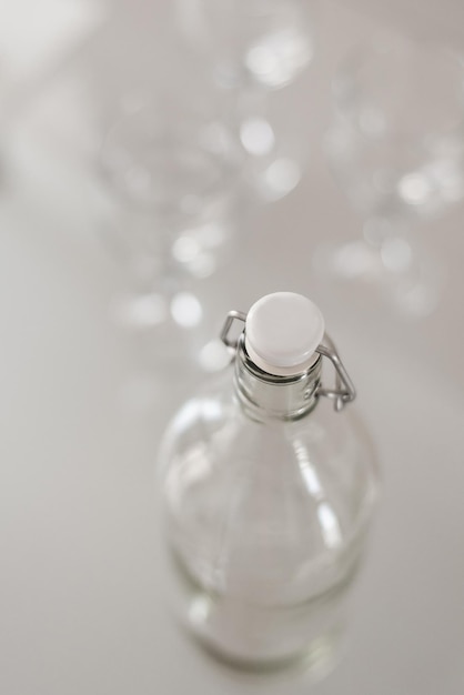 Empty bottle and blurred wine glasses. Glassware set. Catering concept