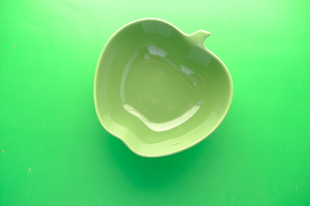 Empty bowl on green background top down