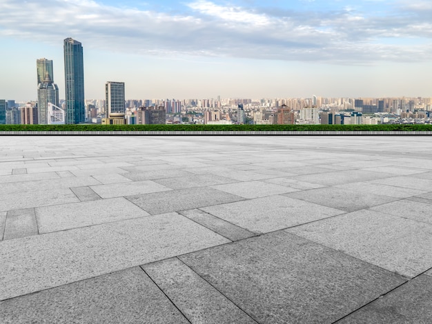 Empty brick floor with city skyline background