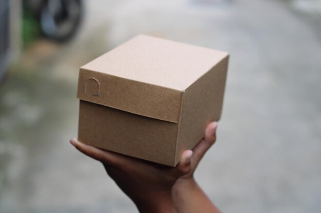 Empty brown cardboard photo held in hand