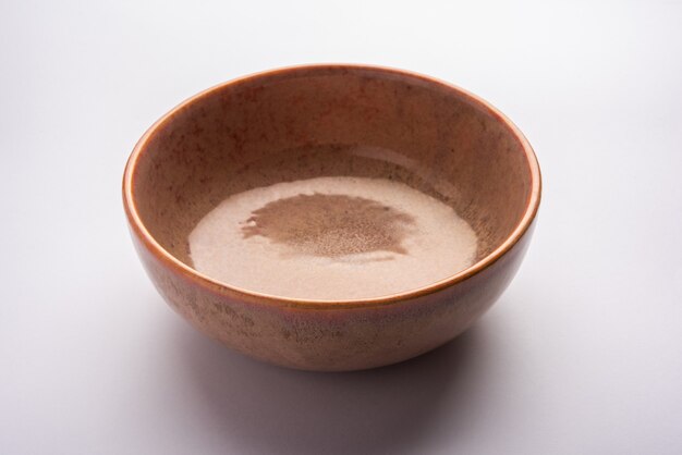 Empty brown ceramic serving bowl, isolated over white or gray surface