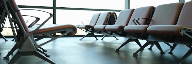 Empty brown leather chairs in airport lounge